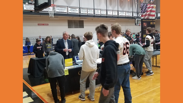 gym full of tables and students